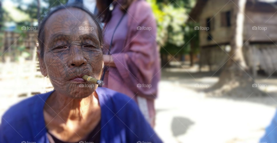 can see how much she enjoy smoking, tatoo on face woman in Myanmar