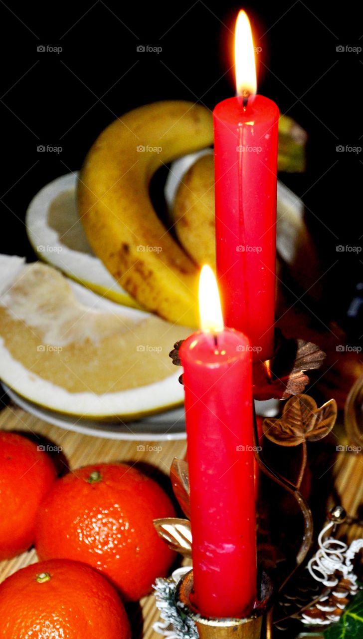 Red candles and fruits 