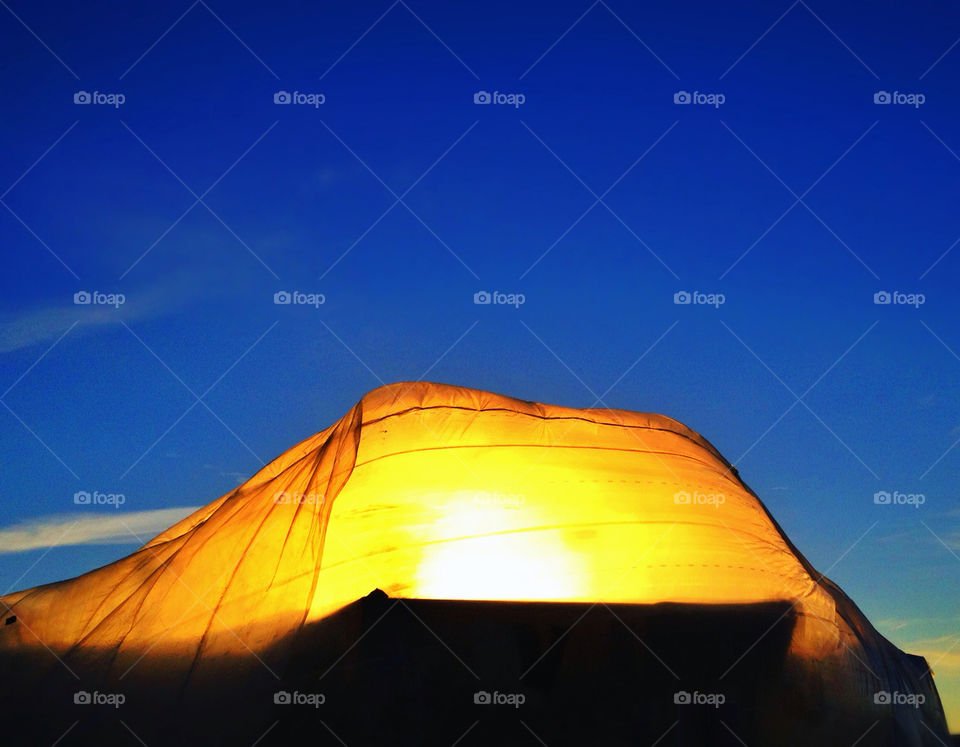 The midwinter sun sets behind a building project in Anchorage, Alaska.