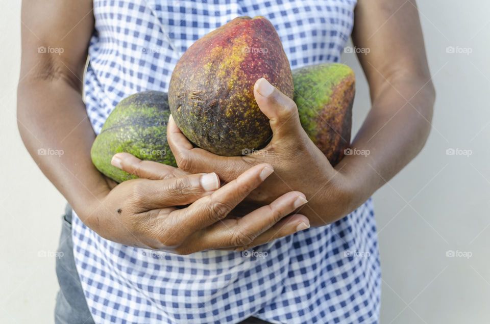 Holding Avocadoes In Both Hands