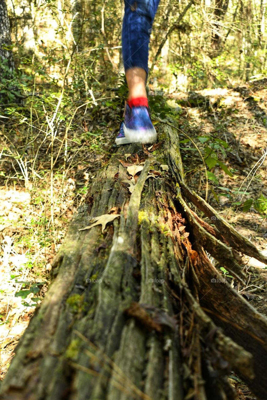 A girl walking on a log