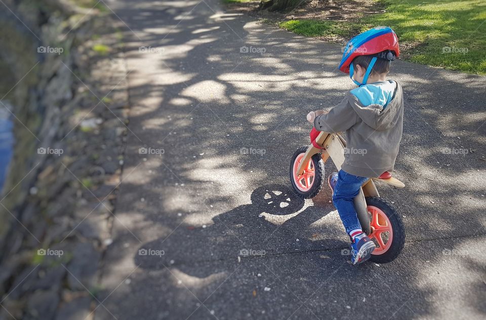 Little boy riding bicycle in park