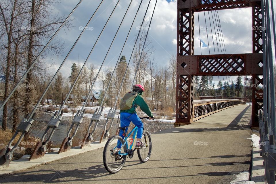 Crossing the bridge by bicycle