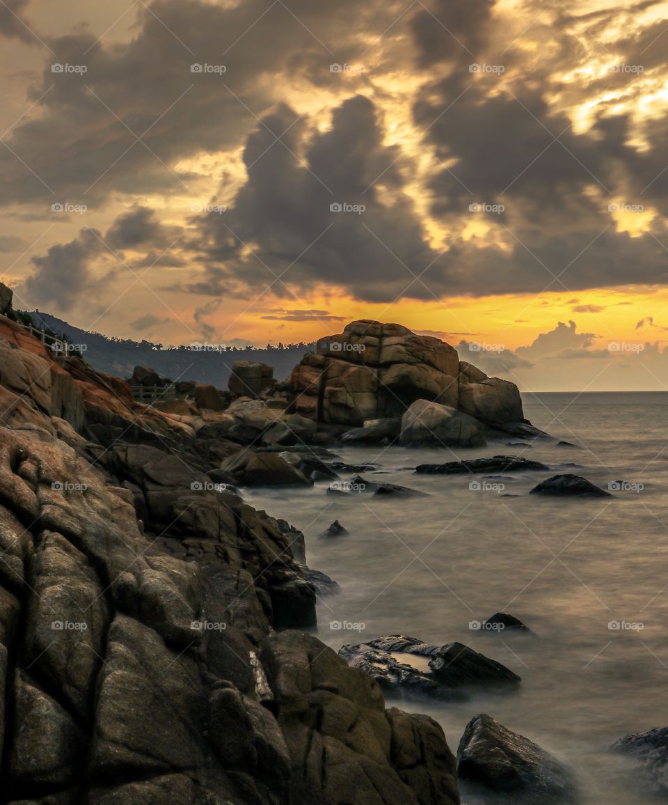 Sunrise Dawn, with a moody sky and dramatic Coastline.. Captured in East coast of Macau