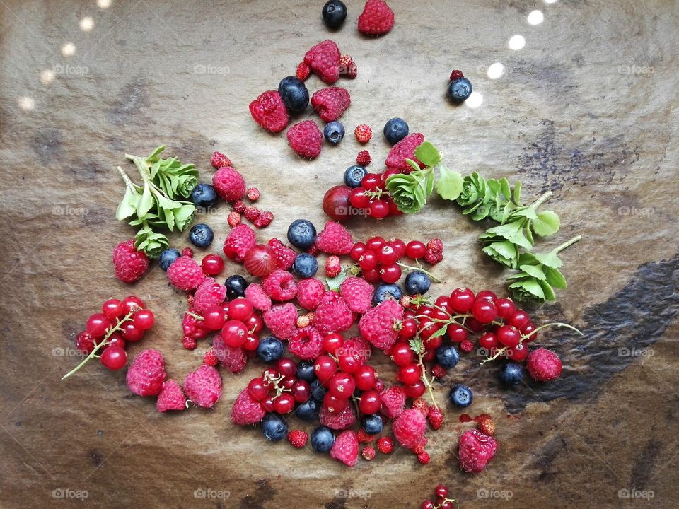 Different berries and green leaves