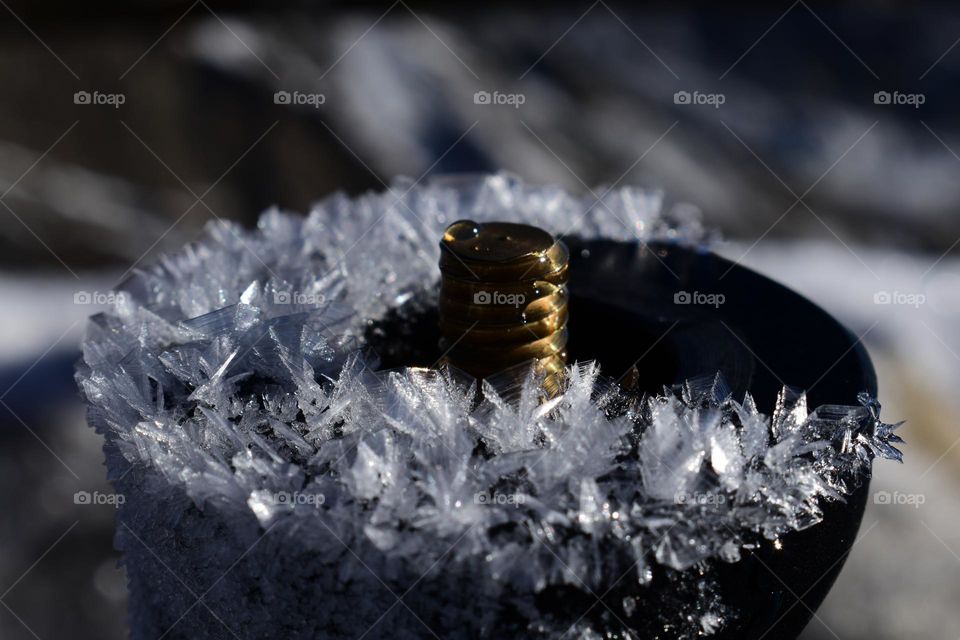 tripod with frozen flakes of snow