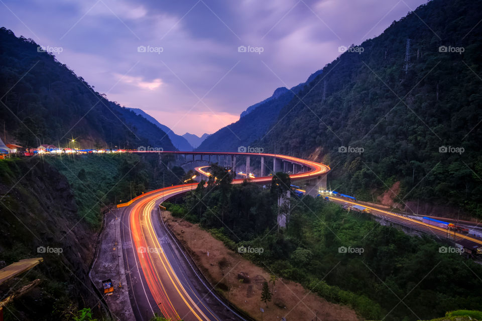 Beautiful light trail in the stretch of winding road of kelok 9, the countryside in West Sumatra, Indonesia