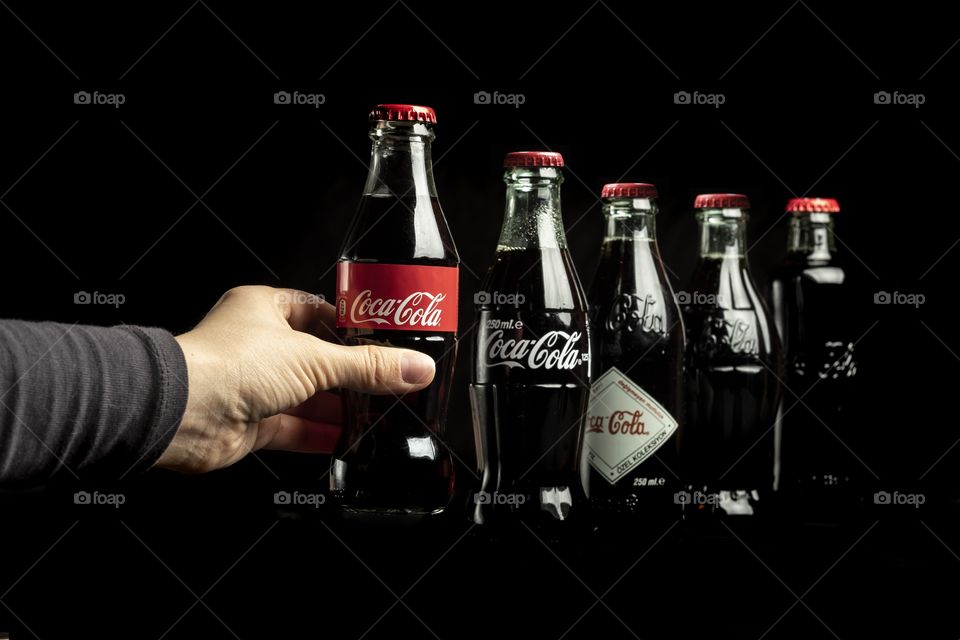 Holding the newest Coca Cola bottle