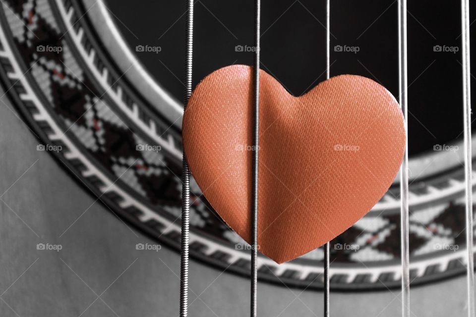 Fret Love. Red love heart within strings of a guitar