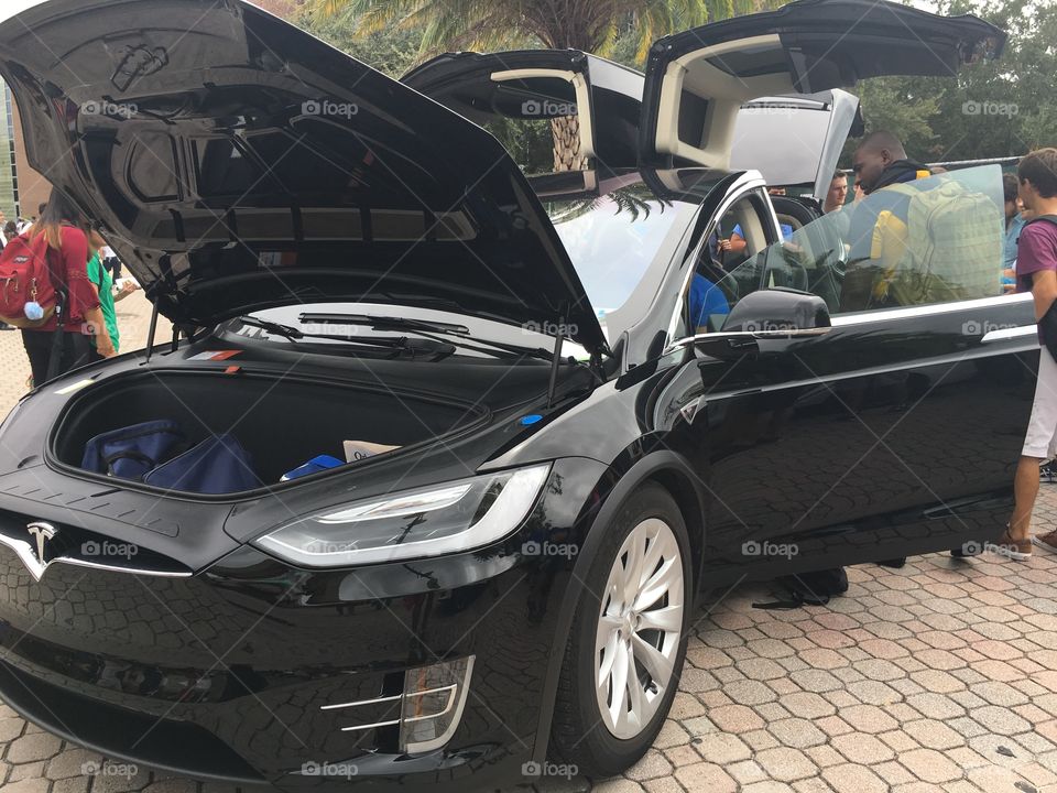 Black tesla with falcon wing doors located at the University of Central Florida.