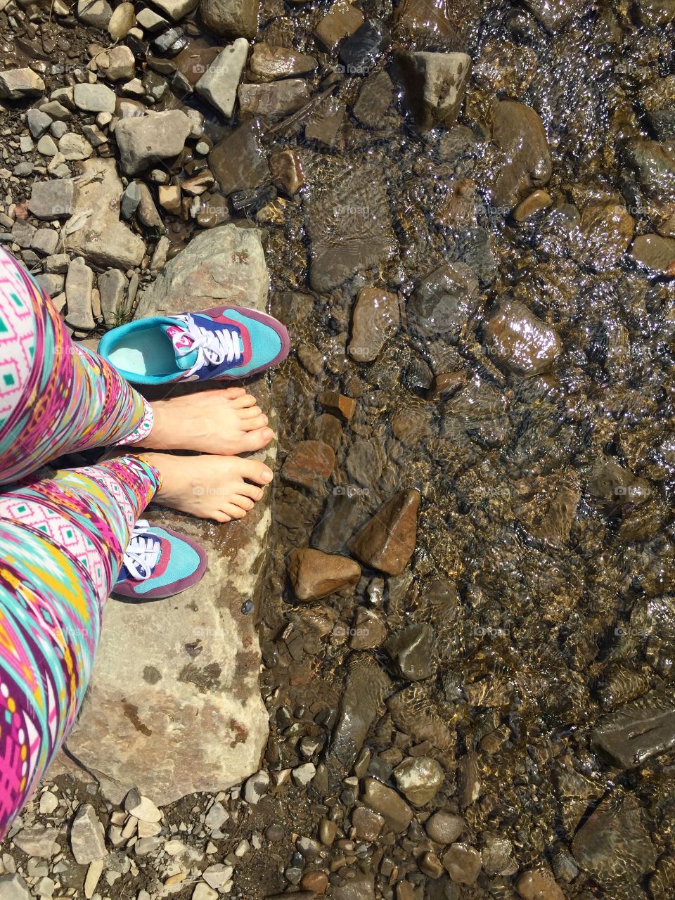 Barefoot on the bank of mountain river