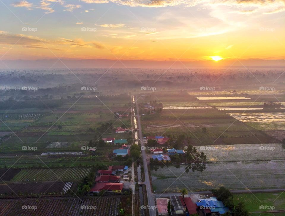 Aerial view of sunrise over the paddy village