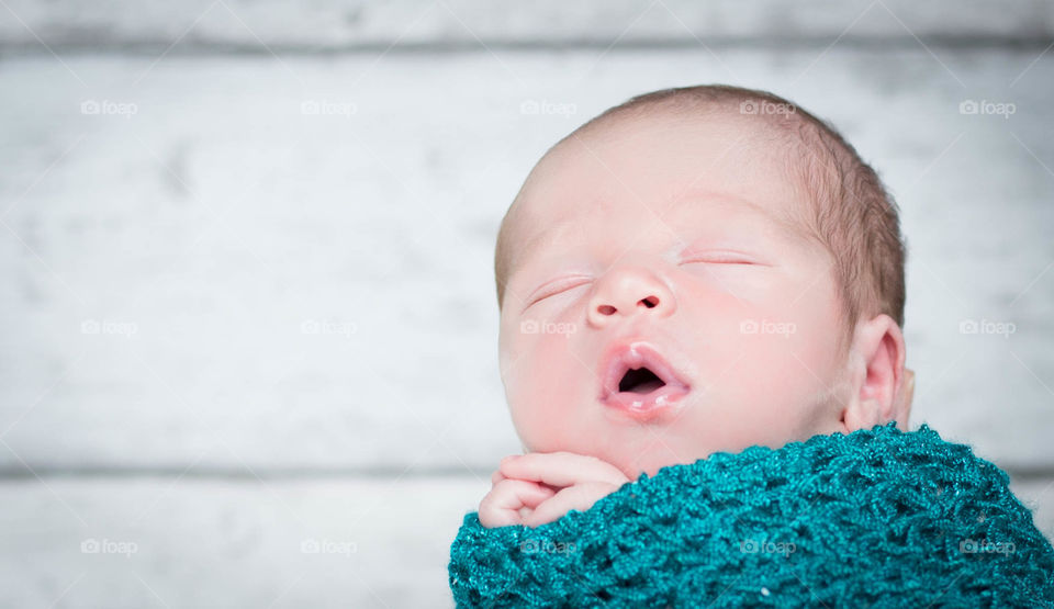 Sleeping baby wrapped in blanket