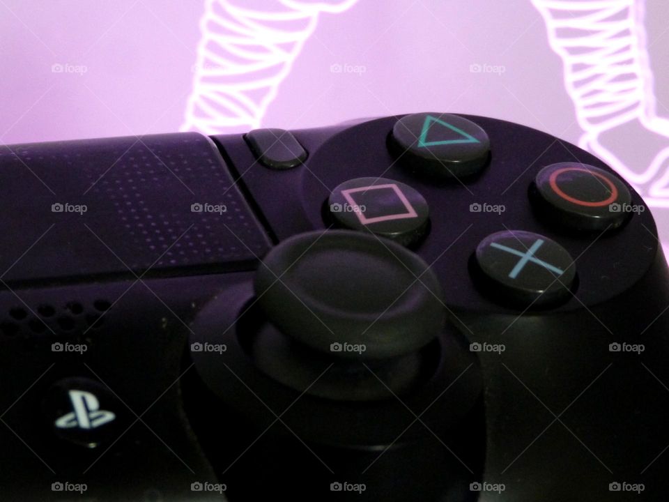 A PlayStation controller presented in front of light decorations.