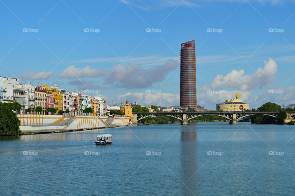 View of Barrio de Triana and Triana  Bridge from river Guadalquivir, Sevilla, Spain.