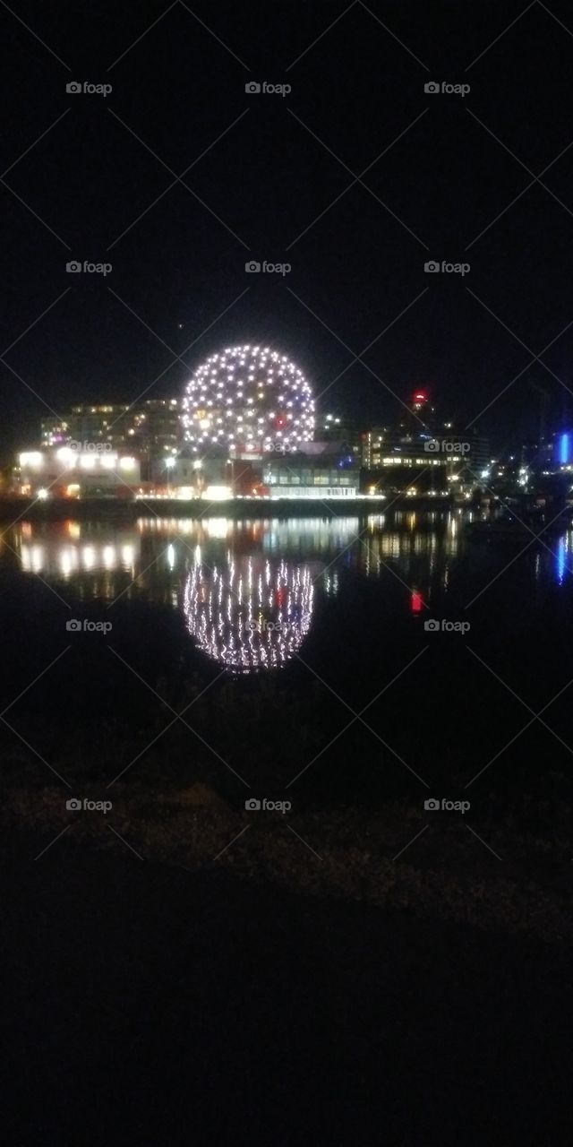 Starry lights brighten the calm waters
