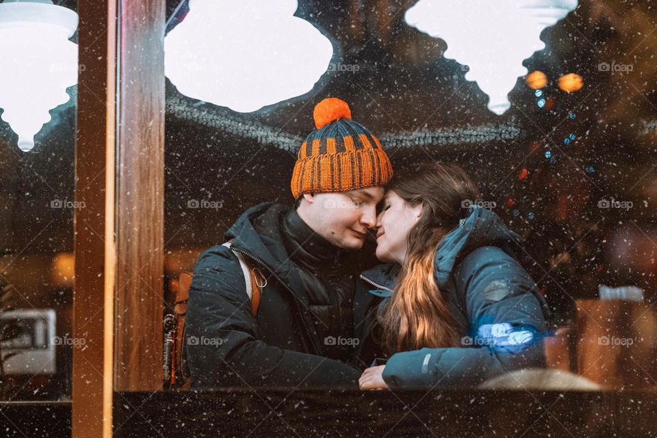 Tender couple kissing in the cafe