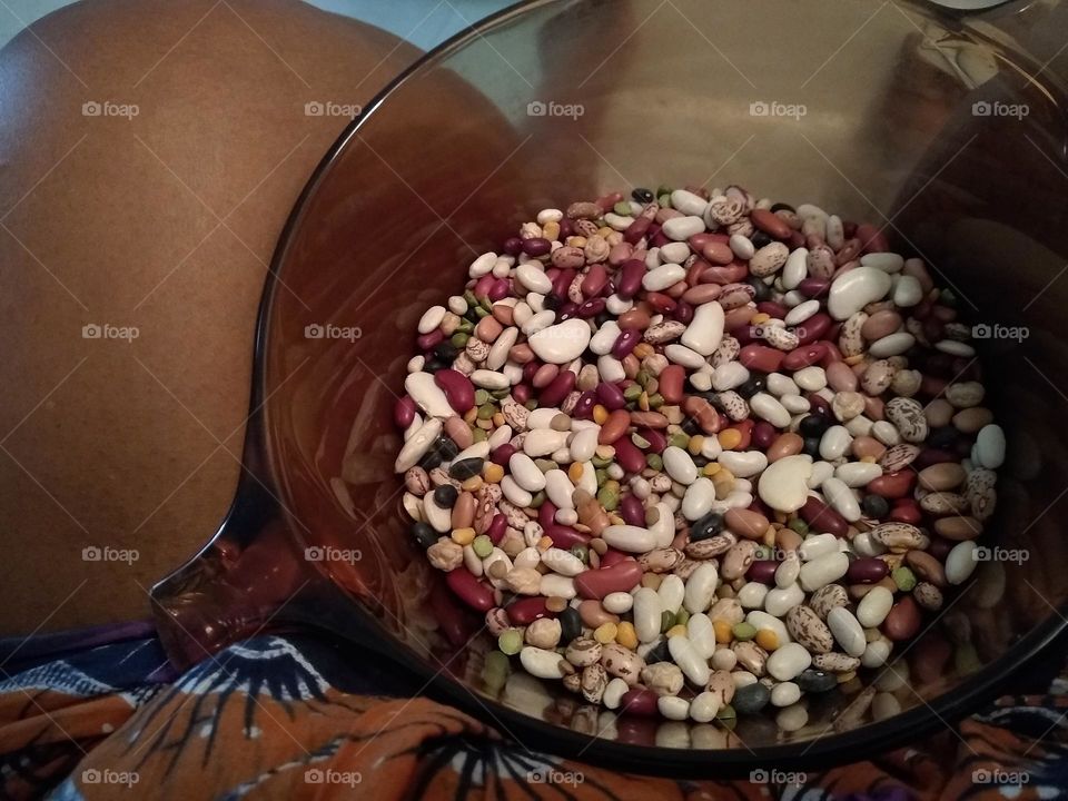 Sorting✋🏾 through a bag of beans and then transferring them to pot 🍲.