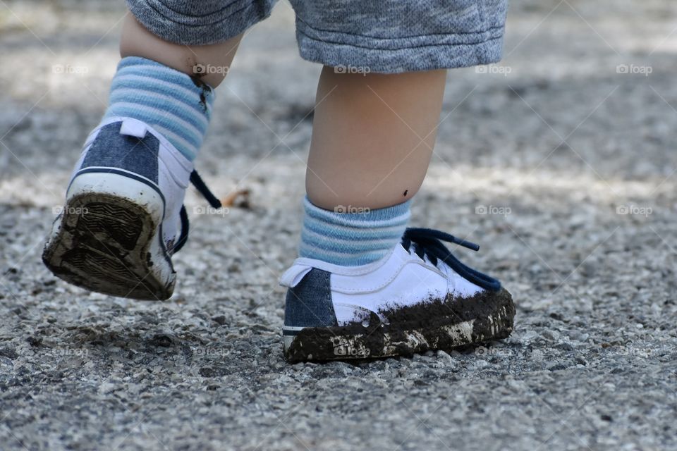 Cute toddler boy muddy shoes 