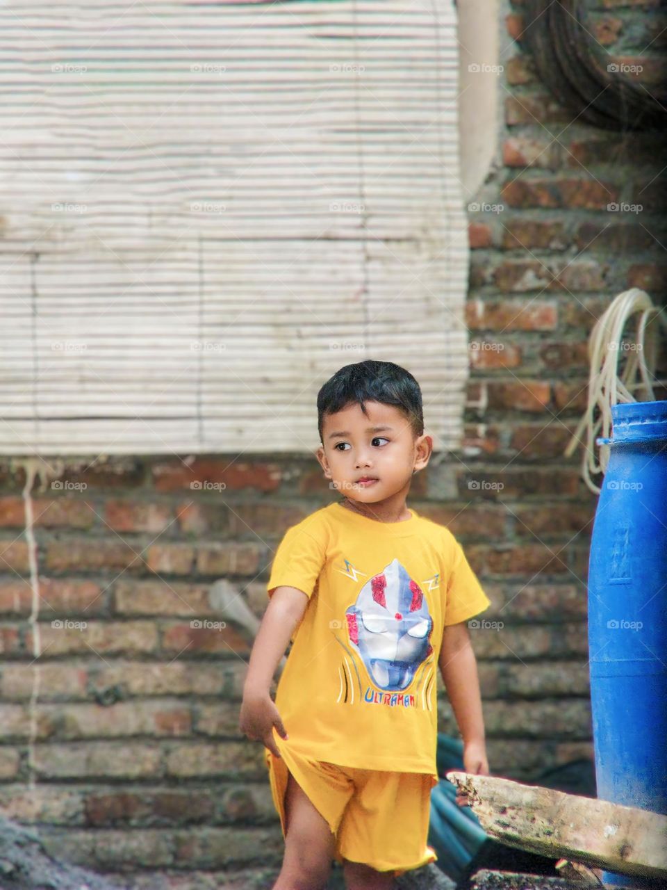 Semarang, Central Java, Indonesia - December 12, 2023: asian boy with a toy in the village