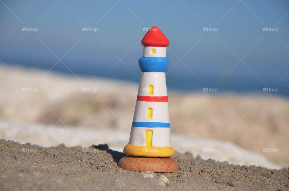 Lighthouse model with beach background