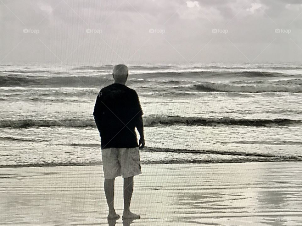 Man looking at the waves 