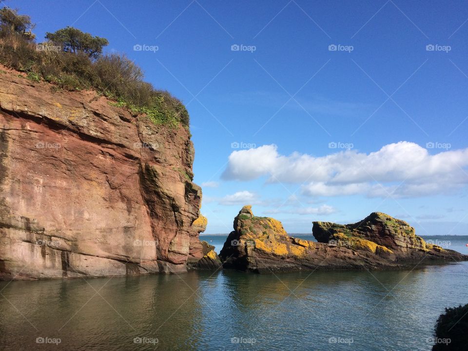 Cliff face at water’s edge on a sunny day