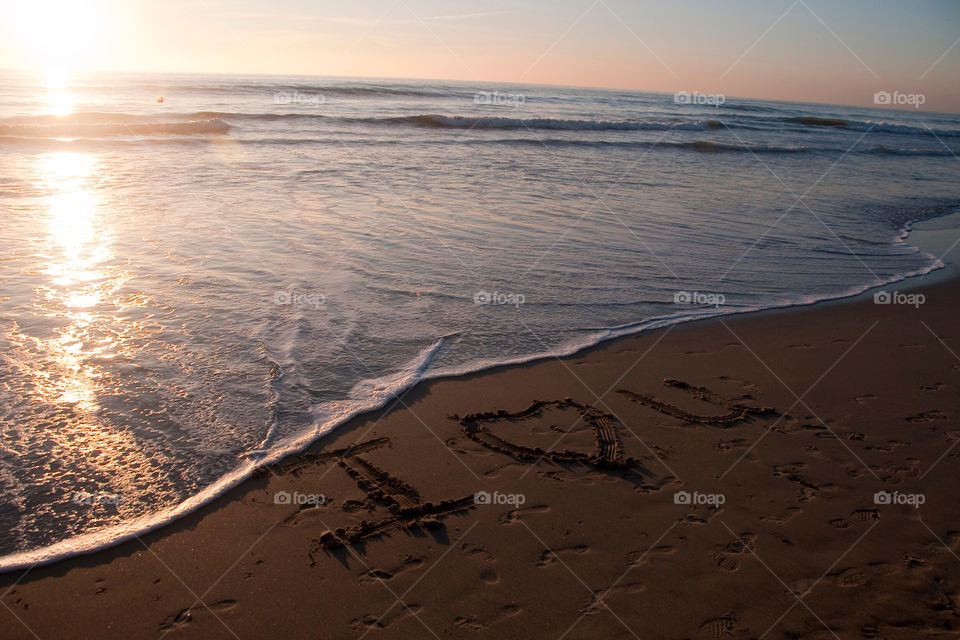I love you written in the sand on the beaches of California at sunset