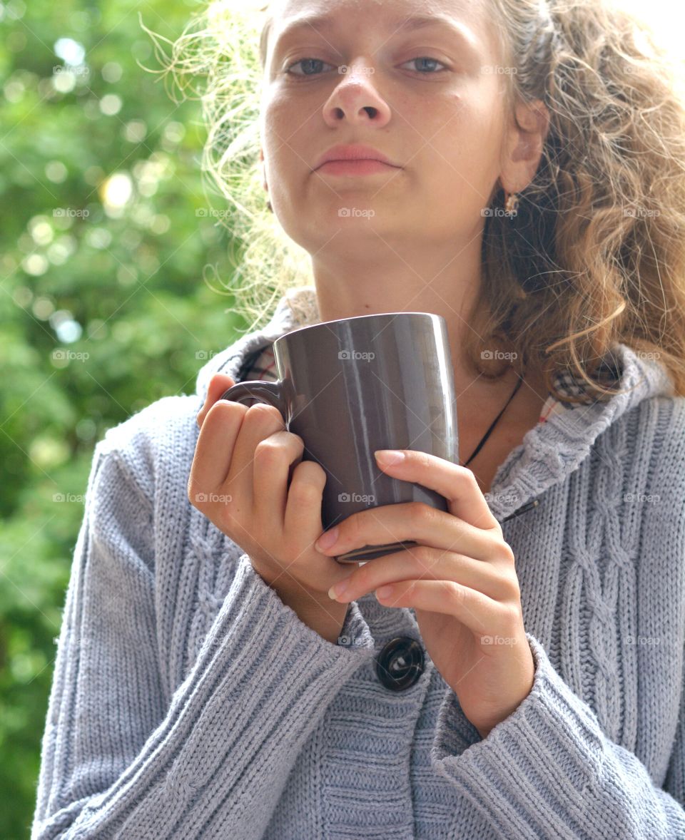 teenage girl with cup green background