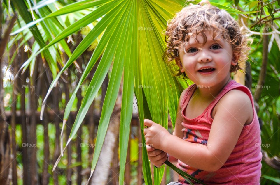 Baby holding palm, leaf