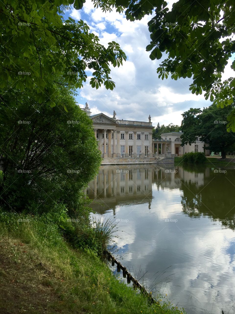 Lazienki Krolewskie castle from side view covered with trees