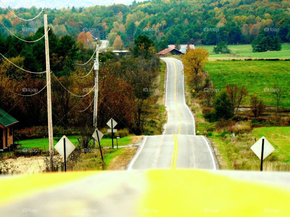 Ribbon of road. The yellow line off the highway goes up and down the hills in the Adirondacks New York