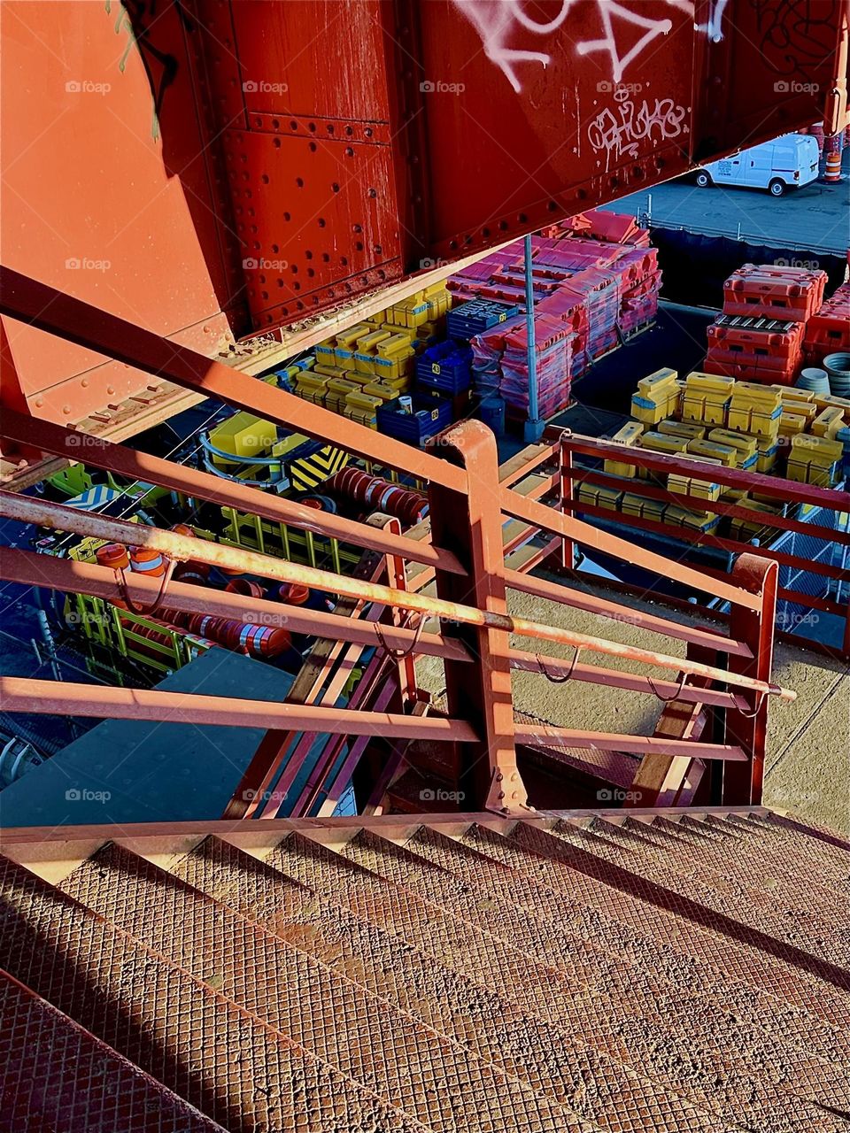 This is the very „Bauhaus“ red metal staircase of the „Pulaski Bridge“ at „Newtown Creek“ in LIC. Its structures look like modern art from certain angles especially when the setting sun illuminates them and adds shadows. 2024. Hypnotic Productions