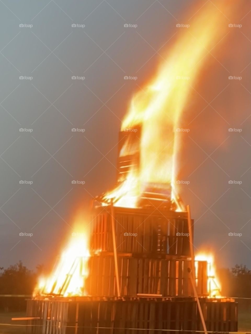 A blazing bonfire warms the chilly autumn air. A24 foot stack of pallets makes the perfect raging fire. 