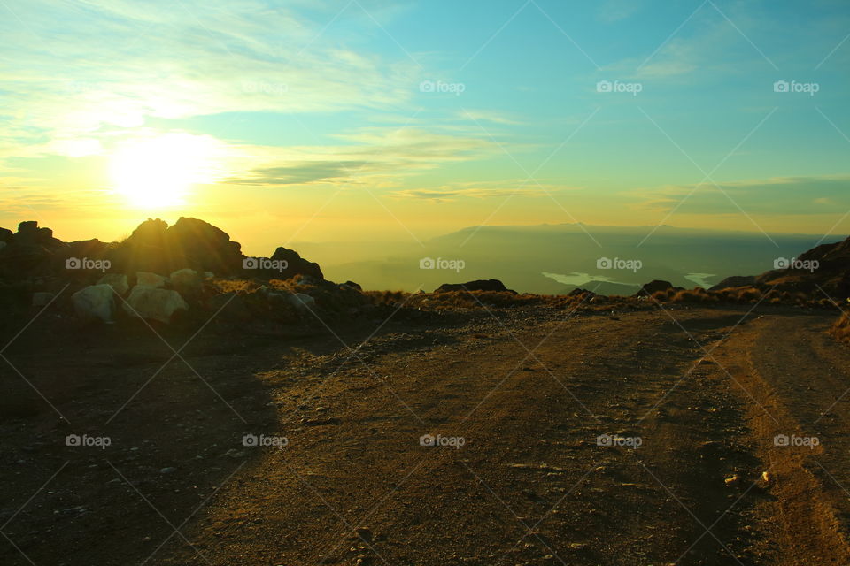 rural trail at sunset. road at top mountain at sunset