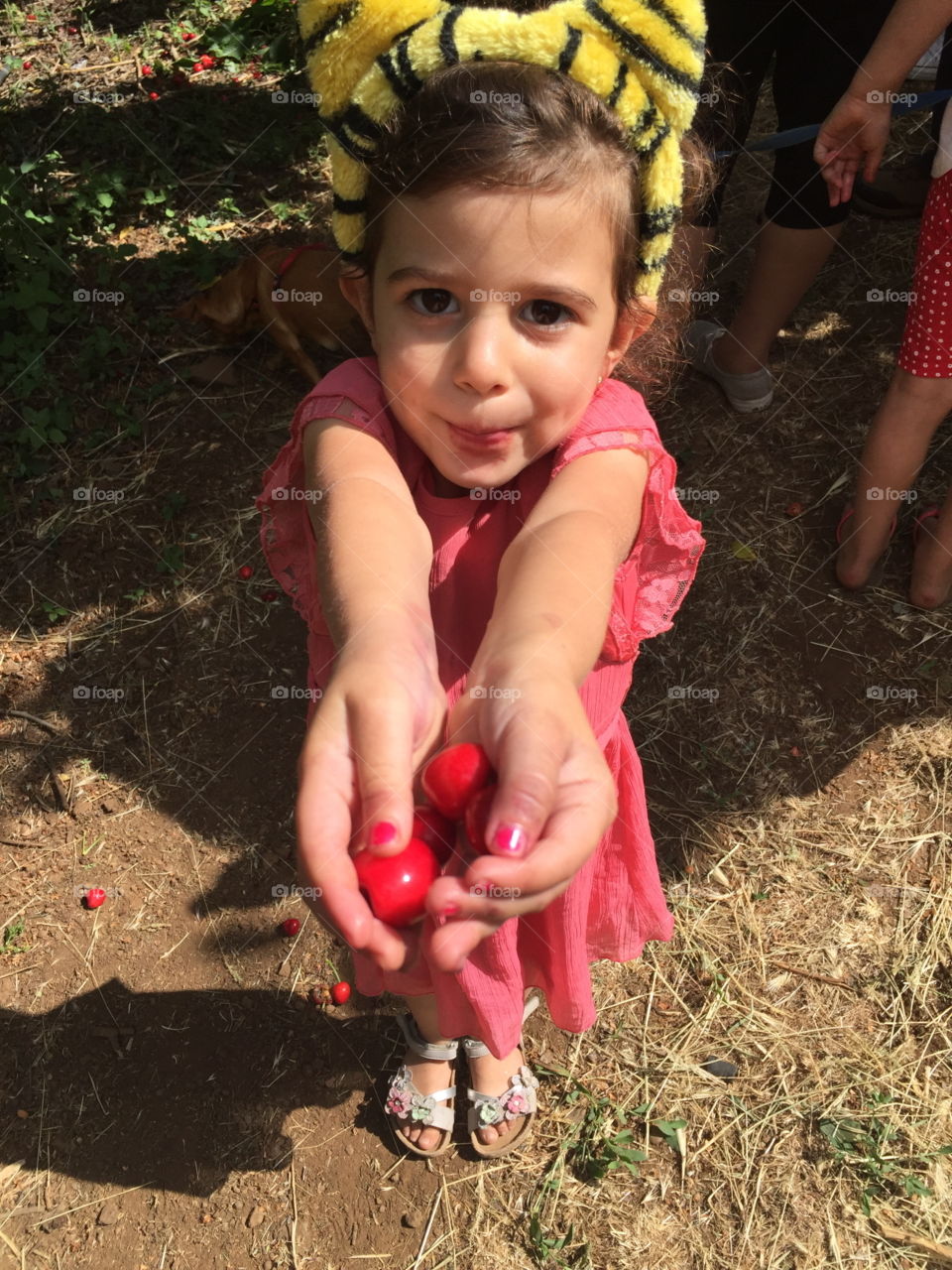 Girl holding cherries in hand