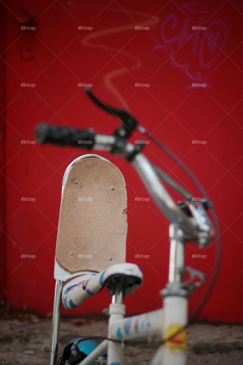 Close of a bike on red wall