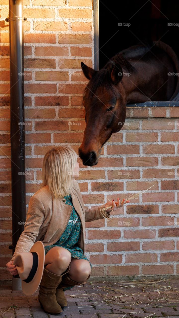 Mutual love. Boho style. A woman and a horse.