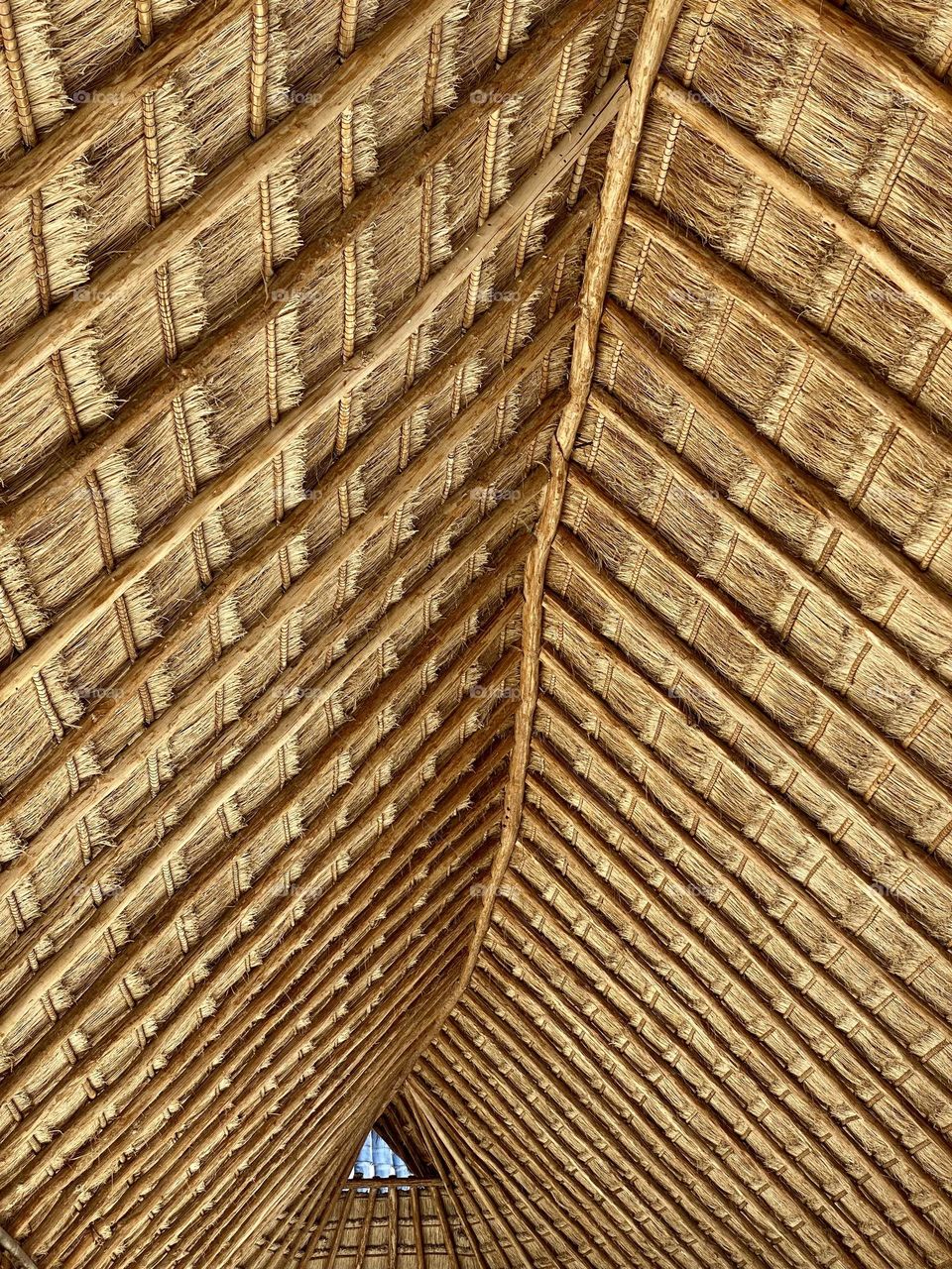 A roof made out of wood and straw