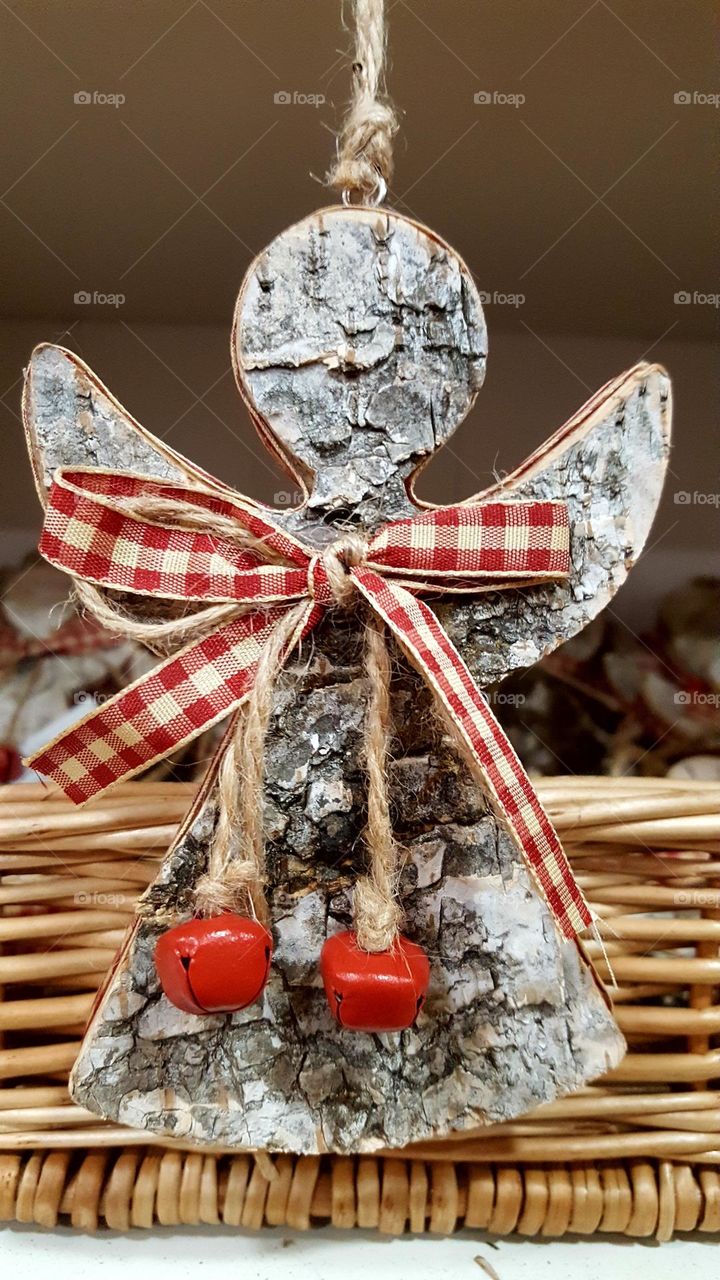 An angel made by hand from the bark of a tree.