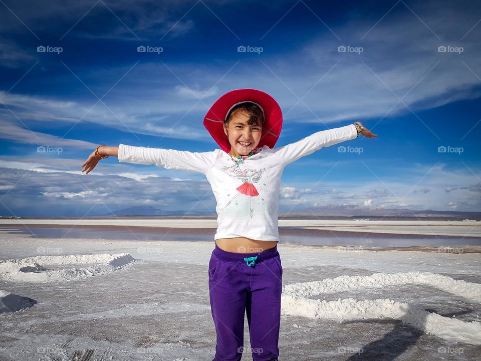 Cute happy girl in Salar de Uyuni