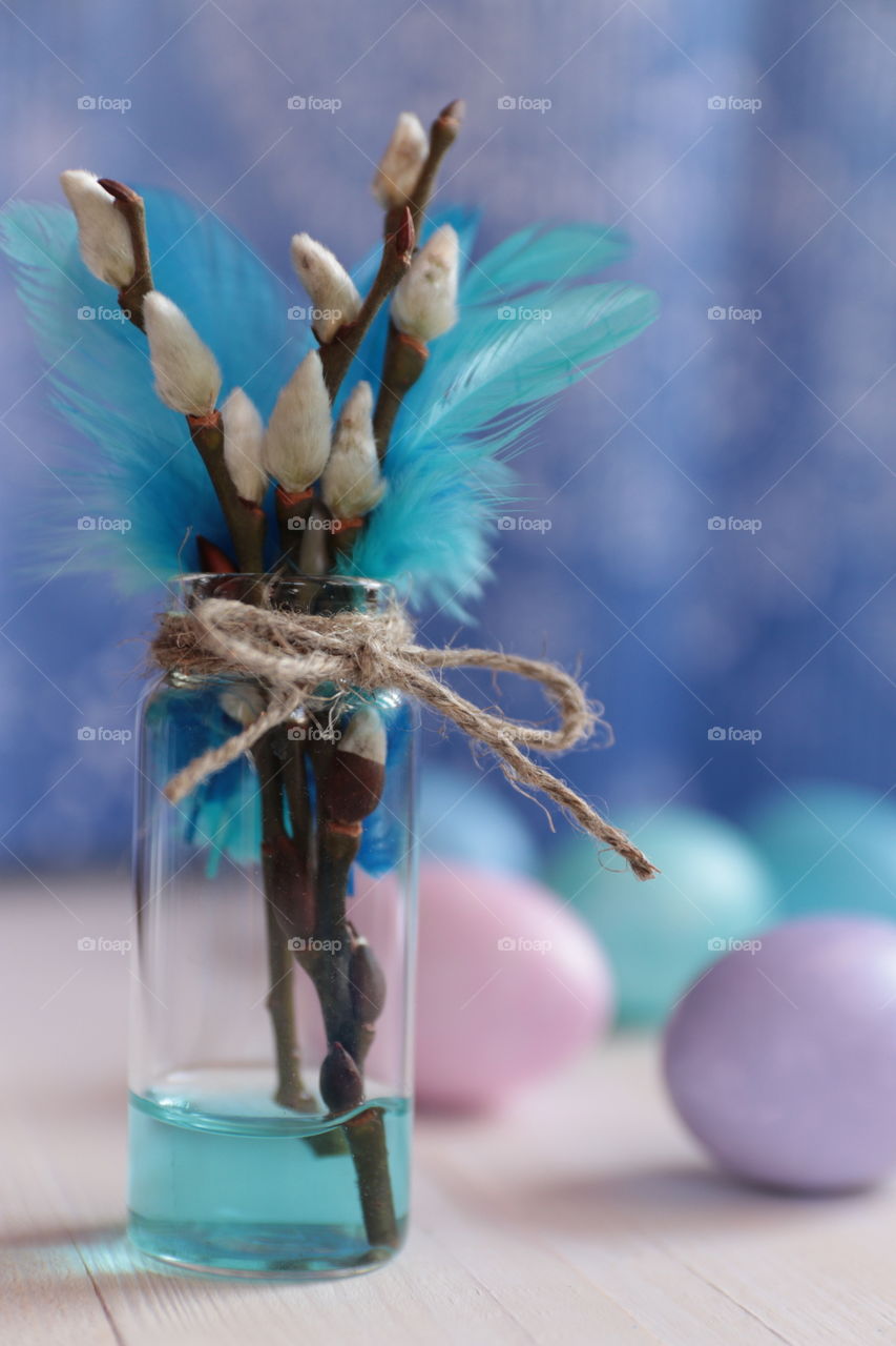 Easter color eggs and willow in glass vase 