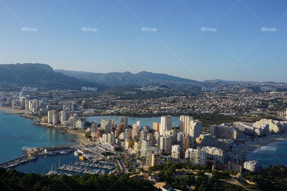 City#view#port#sea#buildings#boats#mountains