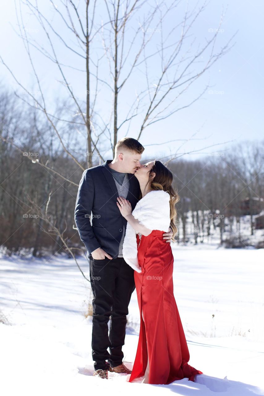 From then and until now, I love you. Couple in front of a snow scene