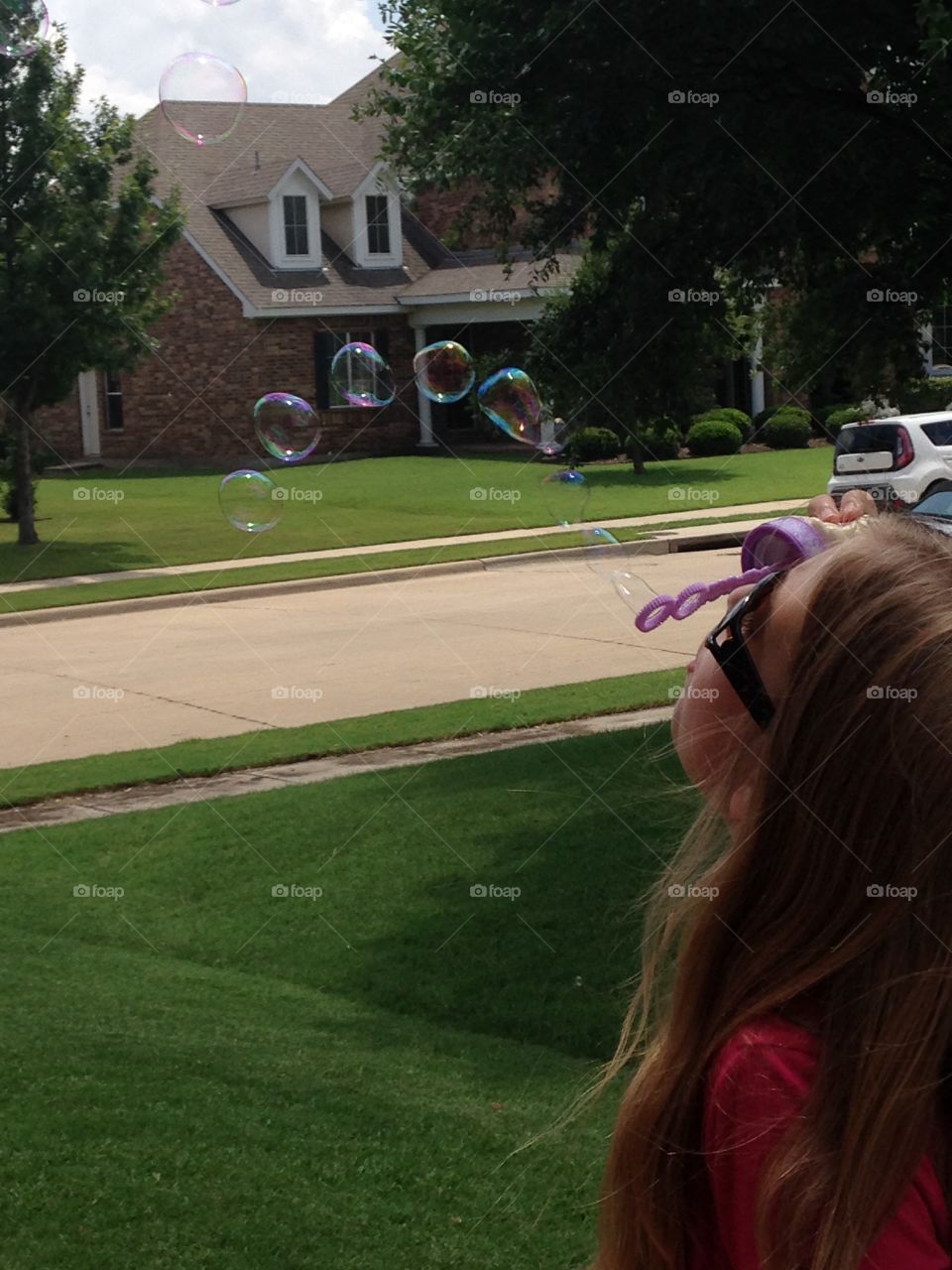 Bubble rainbow. Girl blowing bubbles