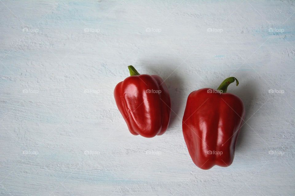 two red peppers white background, lifestyle