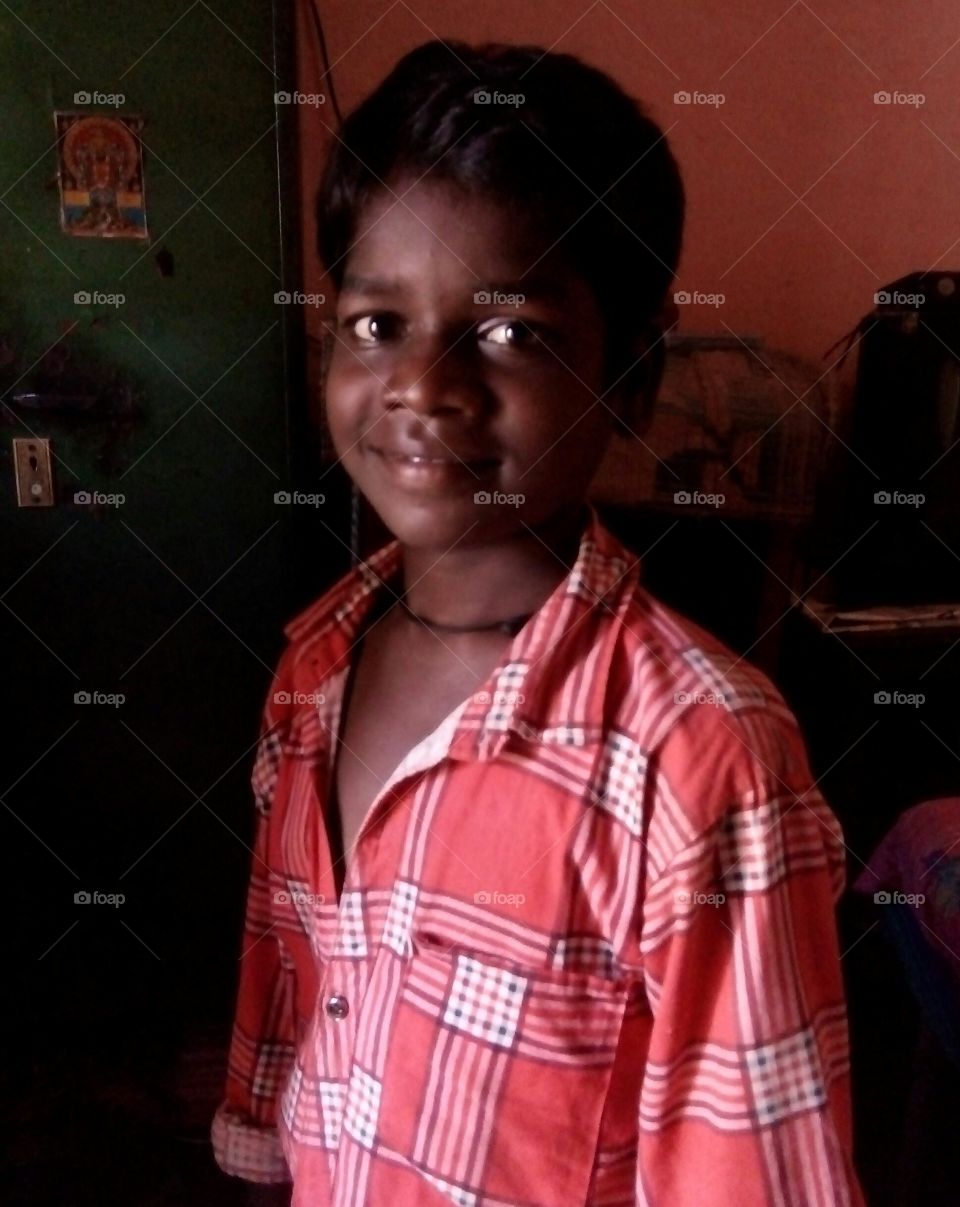 Photographs of a boy / photos of a boy in the dark and light / photos of an Indian boy / an Indian boy with a wizard smile  For one/We smile looking at you / this is my smile for you / if you look at me, i will see you smiling/How are you ?