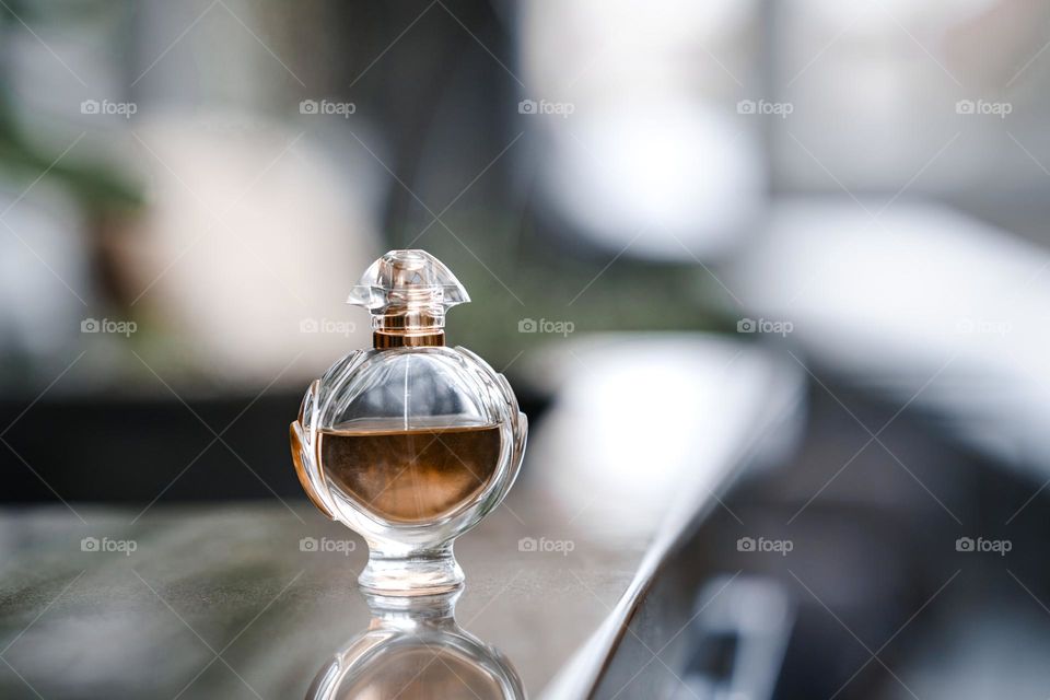 A bottle of perfume on the table. One object only