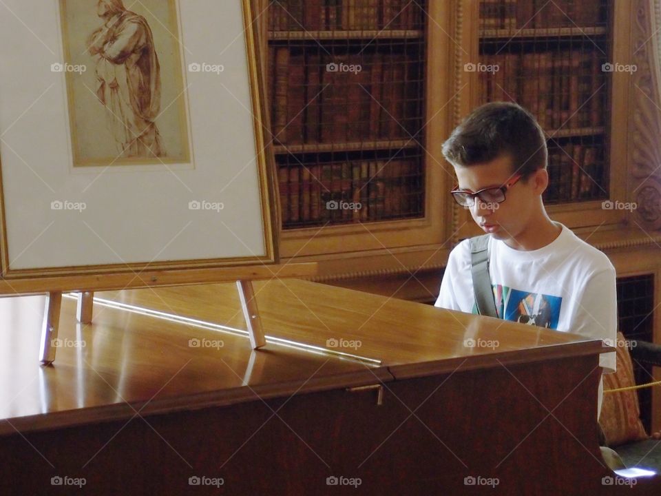 A young boy sits at an antique piano in a large hall at Castle Howard in England and plays like a master much to the delight of a large crowd of passing tourists and staff alike. Everyone knew they were in the presence of a true prodigy. 