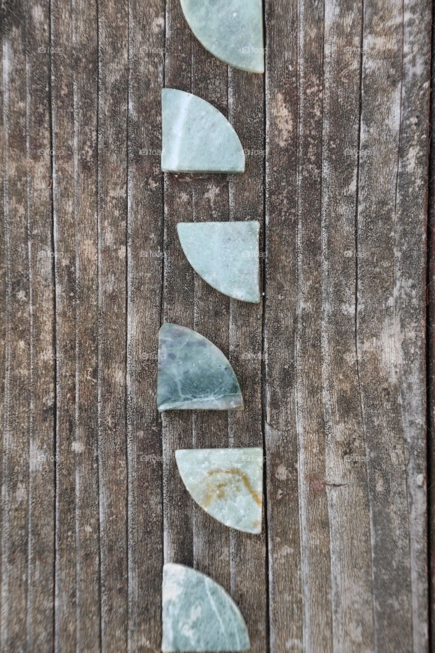 green stone shapes on wood